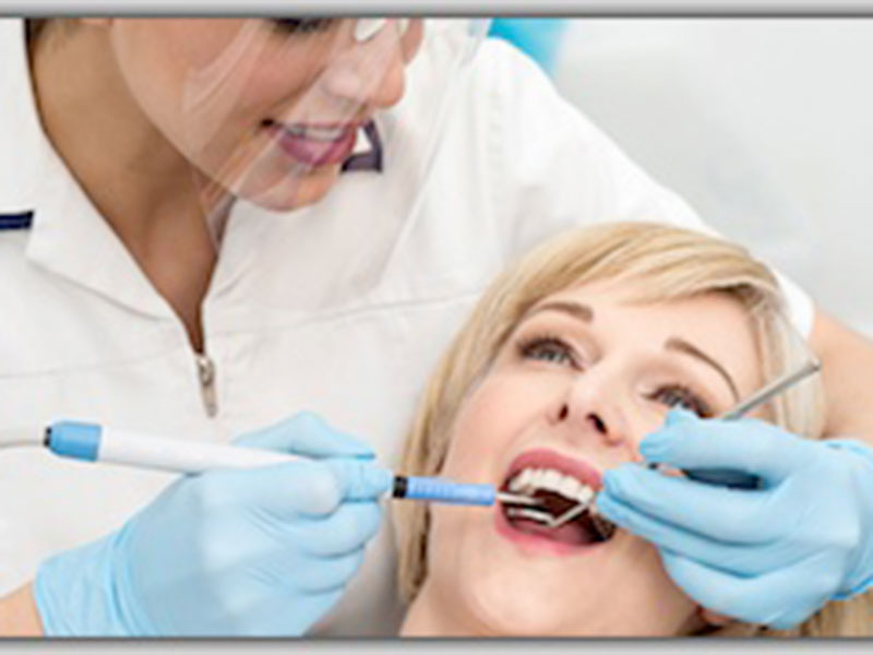 a doctor treating a woman teeth