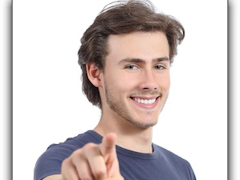 a man smiling and showing his teeth