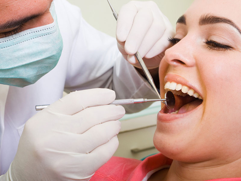 a doctor treating a woman teeth