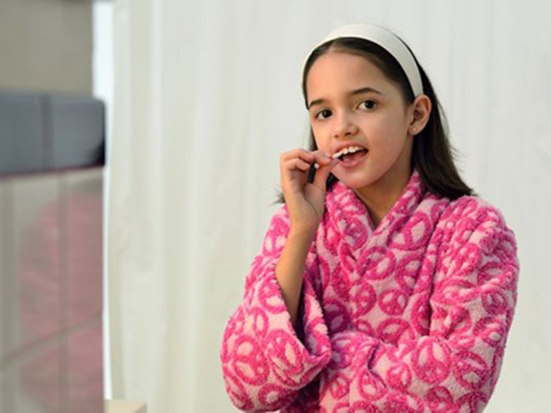 a girl brushing her teeth