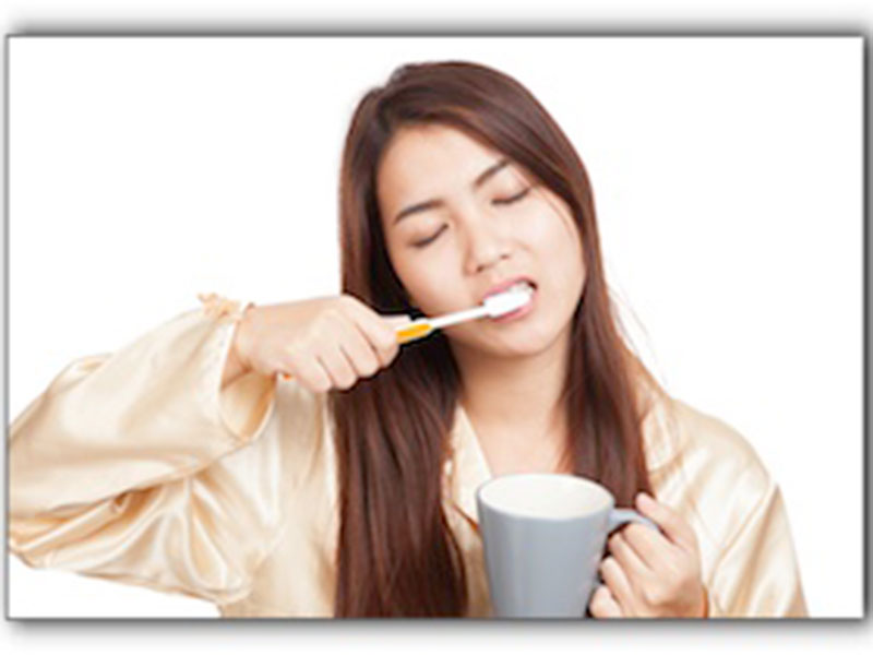 a woman cleaning her teeth